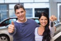 Smiling couple holding their new car key Royalty Free Stock Photo