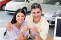 Smiling couple holding their new car key Royalty Free Stock Photo