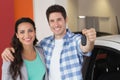 Smiling couple holding their new car key Royalty Free Stock Photo