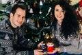 Smiling couple with hot chocolate marshmallow cups