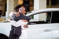 Couple collecting new car from salesman on lot Royalty Free Stock Photo