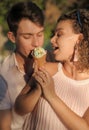 Smiling couple with ice cream walking outdoors Royalty Free Stock Photo