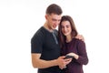 Smiling couple interested look at mobile phone Royalty Free Stock Photo