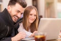 Smiling couple with a laptop