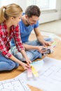 Smiling couple looking at color samples at home Royalty Free Stock Photo