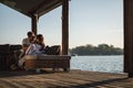 Smiling couple looking at each other by the river