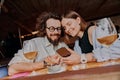 Smiling couple in love looking at photo on phone while drinking in bar on date Royalty Free Stock Photo