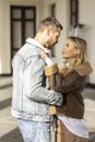 A smiling couple is in love outdoors.A young happy couple embraces on a city street