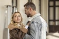 A smiling couple is in love outdoors.A young happy couple embraces on a city street