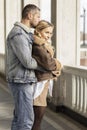 A smiling couple is in love outdoors.A young happy couple embraces on a city street