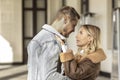 A smiling couple is in love outdoors.A young happy couple embraces on a city street