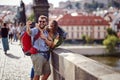 Smiling couple in love walking on a street of Prague city and make selfie