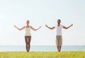 Smiling couple making yoga exercises outdoors Royalty Free Stock Photo