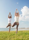 Smiling couple making yoga exercises outdoors Royalty Free Stock Photo