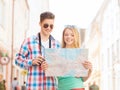 Smiling couple with map and photo camera in city Royalty Free Stock Photo