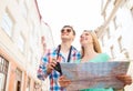 Smiling couple with map and photo camera in city Royalty Free Stock Photo