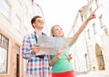 Smiling couple with map and photo camera in city Royalty Free Stock Photo