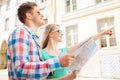 Smiling couple with map and photo camera in city Royalty Free Stock Photo