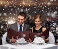 Smiling couple with menus at restaurant Royalty Free Stock Photo