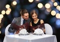 Smiling couple with menus at restaurant Royalty Free Stock Photo