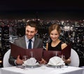 Smiling couple with menus at restaurant Royalty Free Stock Photo