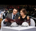 Smiling couple with menus at restaurant Royalty Free Stock Photo