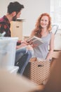 Smiling couple packing stuff into carton boxes while moving-out Royalty Free Stock Photo