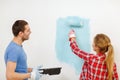 Smiling couple painting wall at home Royalty Free Stock Photo