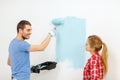 Smiling couple painting wall at home Royalty Free Stock Photo
