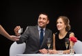 Smiling couple paying for dinner with credit card Royalty Free Stock Photo