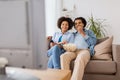 Smiling couple with popcorn watching tv at home Royalty Free Stock Photo