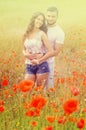 Smiling couple in poppies plants Royalty Free Stock Photo