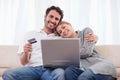 Smiling couple shopping online Royalty Free Stock Photo