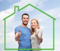 Smiling couple showing thumbs up over green house Royalty Free Stock Photo