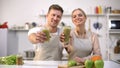 Smiling couple showing vegetable cocktail, healthy lifestyle, vegetarian diet