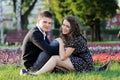 A smiling couple sitting on the grass Royalty Free Stock Photo