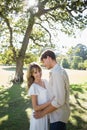 Smiling couple standing and embracing in park Royalty Free Stock Photo