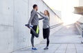 Smiling couple stretching leg outdoors Royalty Free Stock Photo