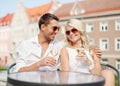 Smiling couple in sunglasses drinking wine in cafe Royalty Free Stock Photo