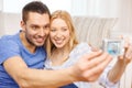 Smiling couple taking picture with digital camera Royalty Free Stock Photo
