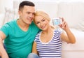 Smiling couple taking picture with digital camera Royalty Free Stock Photo