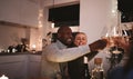 Smiling couple toasting their friends during a candlelit dinner Royalty Free Stock Photo