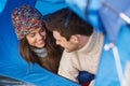 Smiling couple of tourists looking out from tent Royalty Free Stock Photo