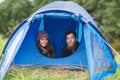 Smiling couple of tourists looking out from tent Royalty Free Stock Photo