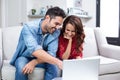 Smiling couple using laptop Royalty Free Stock Photo