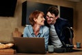 Smiling couple using a laptop at home Royalty Free Stock Photo