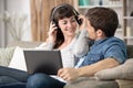 smiling couple using laptop and tablet computers wearing headphones Royalty Free Stock Photo