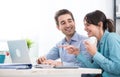 Smiling couple using a laptop Royalty Free Stock Photo