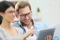 Smiling couple using tablet at home Royalty Free Stock Photo