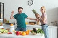 smiling couple of vegans having fun while cooking